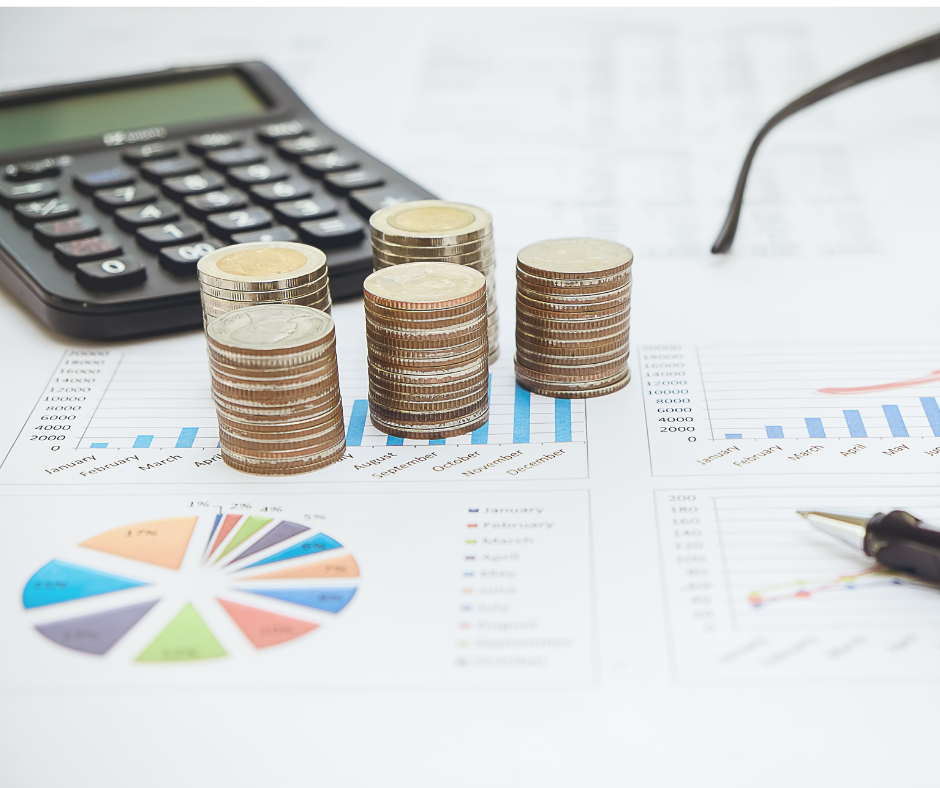 a calculator, some paper, a pen, and money on a desk